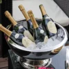 A silver bowl containing six bottles of champagne, elegantly arranged for a celebratory occasion.