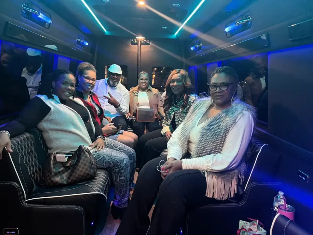 A diverse group of people seated on a bus, engaged in conversation and enjoying their journey together.